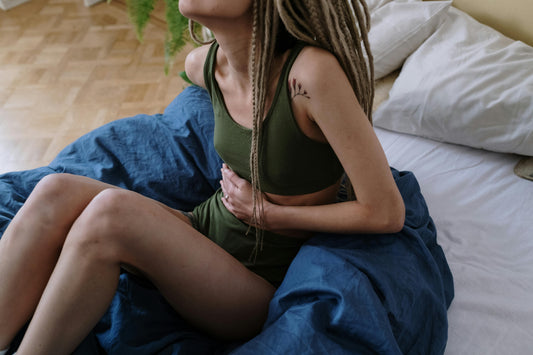 Woman holding her stomach with period pains.