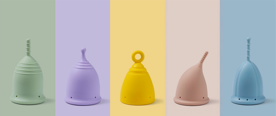 Pastel coloured period cups on a coloured background.