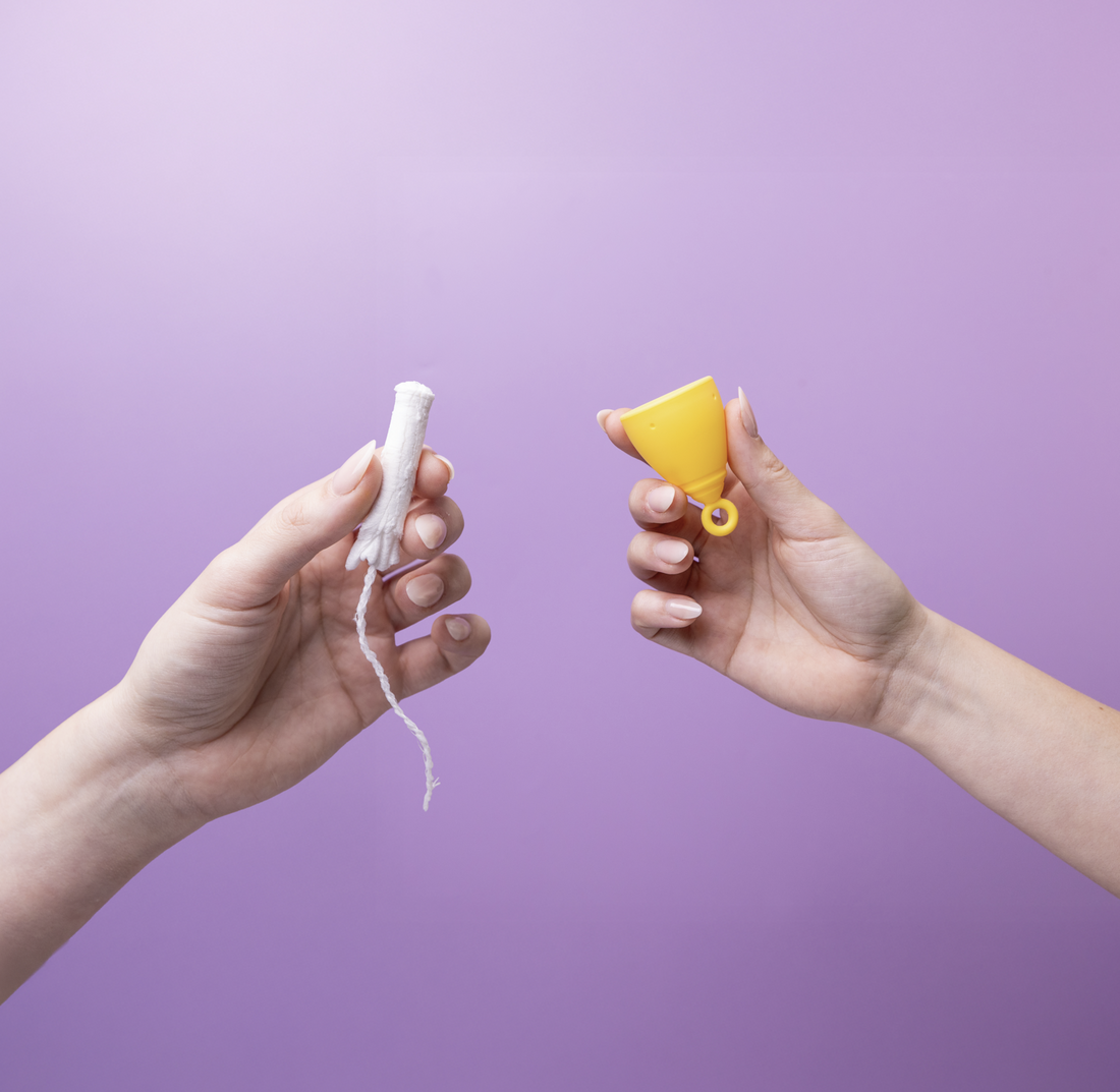 Hands holding a menstrual cup vs tampon
