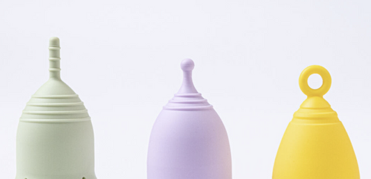 Green, purple, and yellow menstrual cups. 